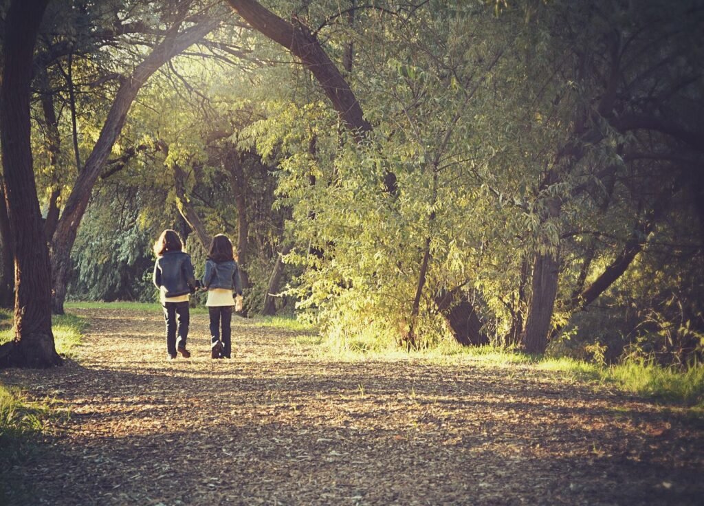 Doctors Prescribe Time in Nature in Expanding Pilot Schemes People walking on a park path among trees