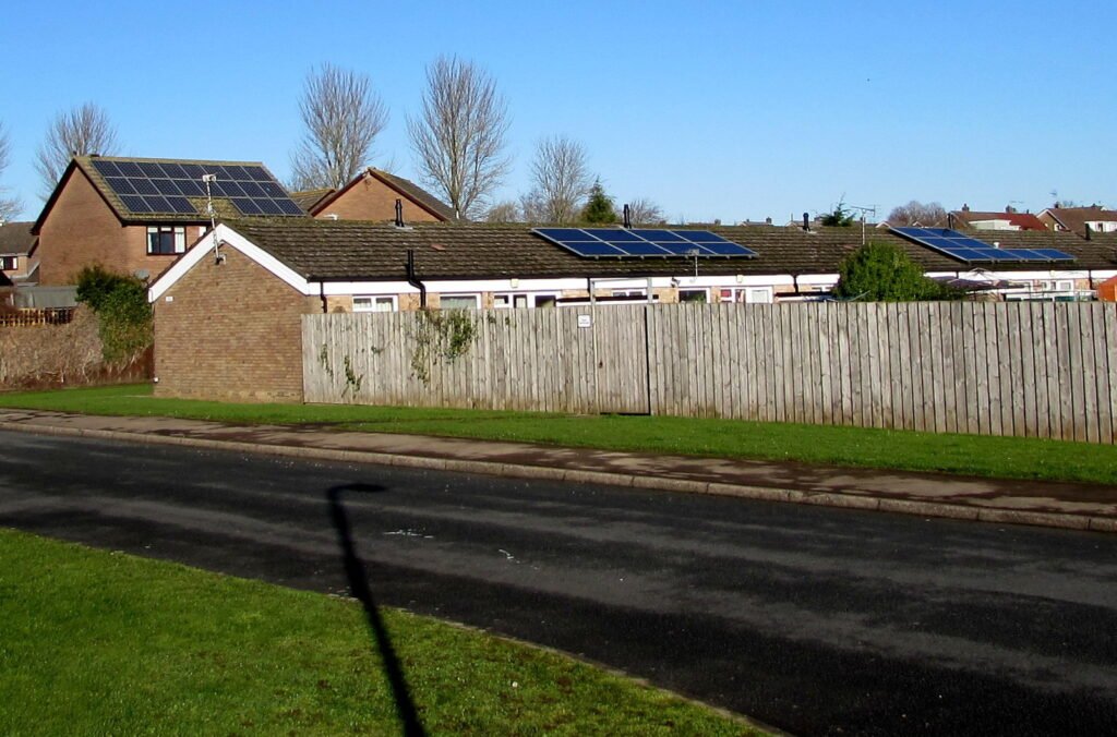 Rooftop solar panels on a family home in bright sunshine